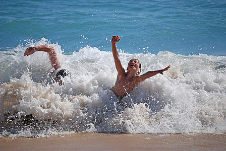 two person swimming on sea during daytime thumbnail