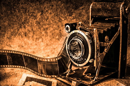 black folding camera on brown surface thumbnail