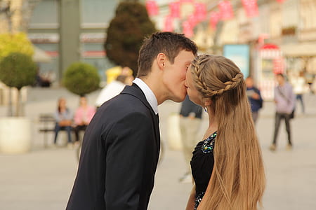 man and woman kissing in the middle of street thumbnail
