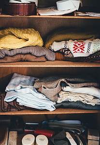 assorted clothes filled wooden rack thumbnail