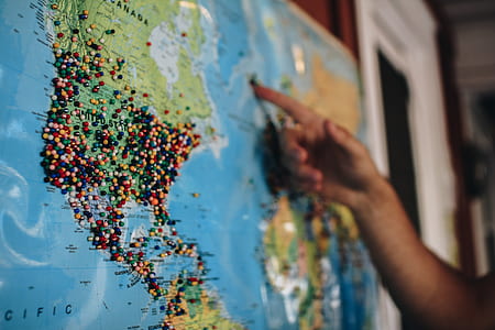 person pointing at a certain location in a map thumbnail