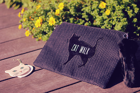 photography of black textile with Cat Walk print near brushes during day time thumbnail