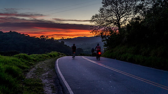 two people riding bicycle on gray concrete road during daytime thumbnail
