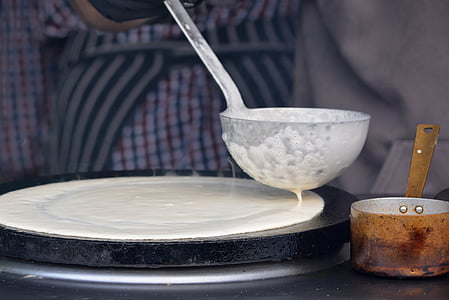 white roti mixture on black griddle thumbnail