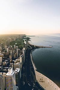 birds eye view of city beside body of water during daytime thumbnail