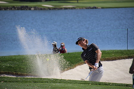 man playing golf on field at daytime thumbnail