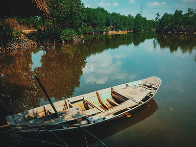 Brown Canoe Boat on Body of Water thumbnail