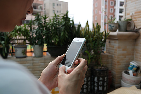 woman holding iPhone 5s thumbnail
