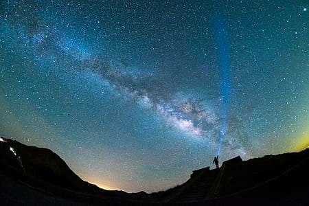 silhouette of person on top of mountain under space clouds thumbnail