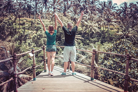 man and woman standing on wooden dock thumbnail