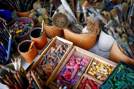 paint brushes and pencils on containers thumbnail