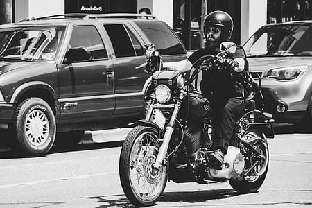 Greyscale Photo Of Man Riding Motorcycle thumbnail