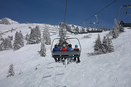 people riding cable cart facing mountain during daytime thumbnail