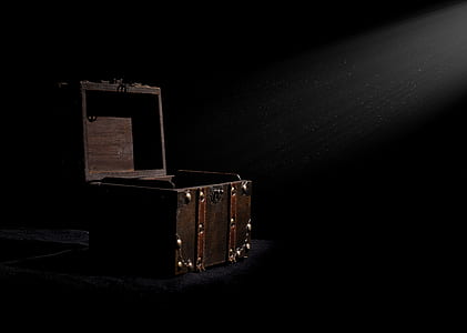 silhouette photography of open brown chest under crepuscular ray thumbnail