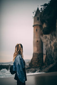 woman standing near brown towerr thumbnail