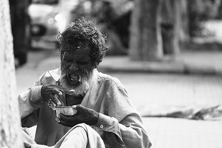 grayscale photo of man holding bowl thumbnail