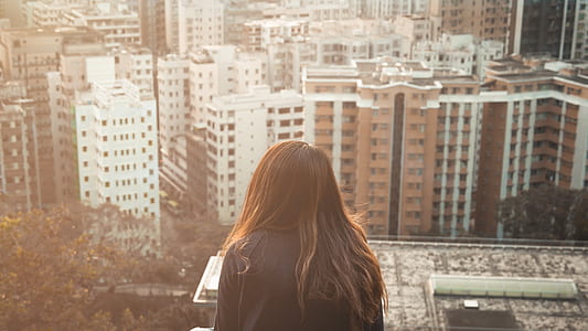 woman staring at city building thumbnail