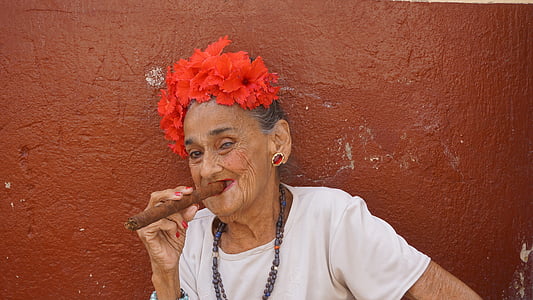 woman wearing white shirt holding cigar thumbnail