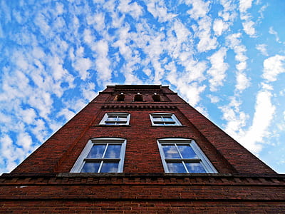 low-angle photography of red concrete building under clear blue sky thumbnail