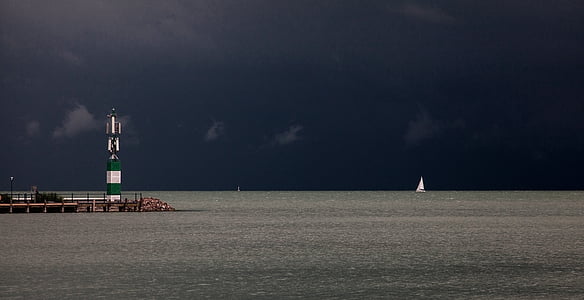 white sail boat at sea thumbnail