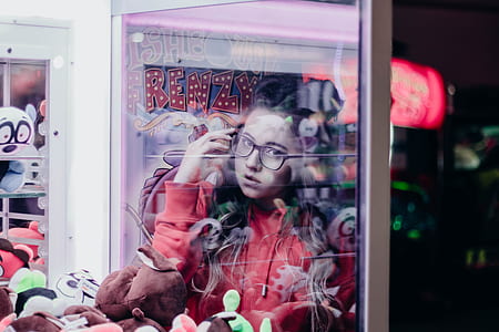 reflection of woman on glass arcade machine thumbnail