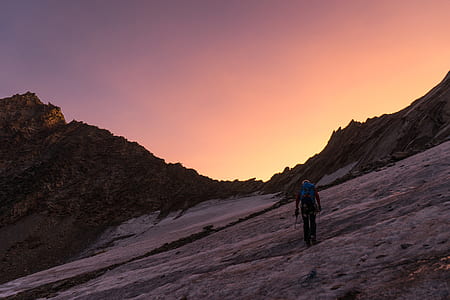 person walking on snow covered mountain thumbnail
