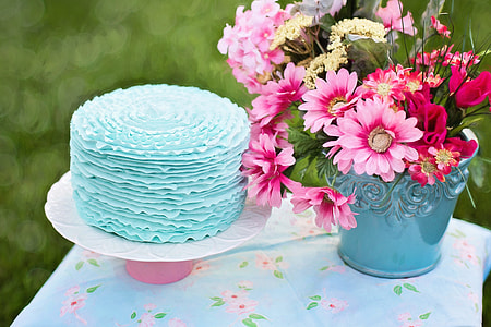 pink petaled flower with green vase on table thumbnail