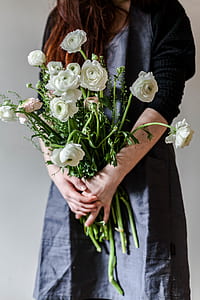 woman carrying white flowers thumbnail