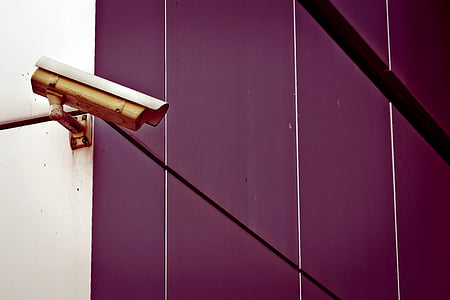 yellow security camera on wall thumbnail