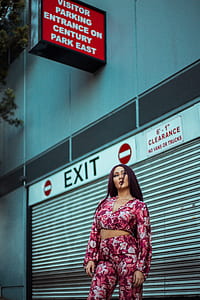 woman standing beside roller shutter thumbnail
