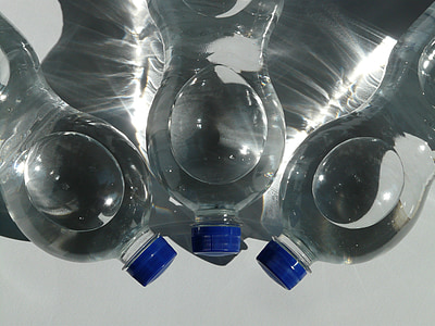 three clear plastic bottles filled with clear liquid thumbnail