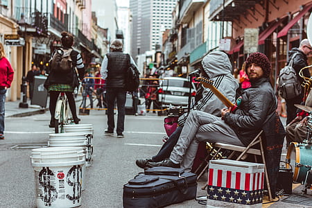 man sitting on chair holding guitar thumbnail