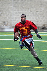 man wearing football uniform running on green field with ball thumbnail