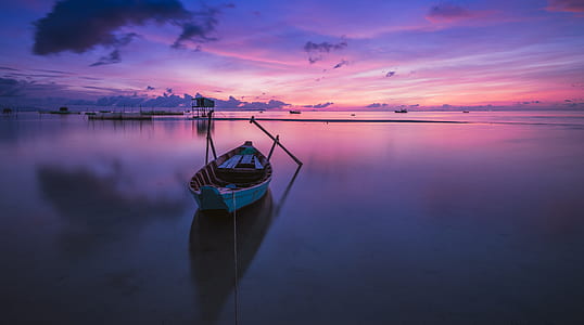 brown boat on body of water thumbnail