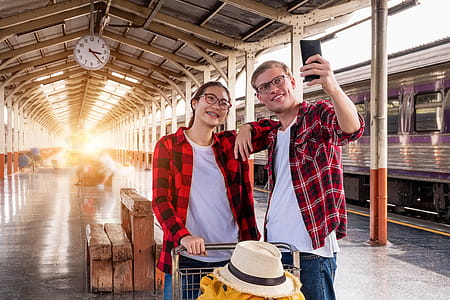 Man and Woman at the Train Station Taking a Selfie thumbnail