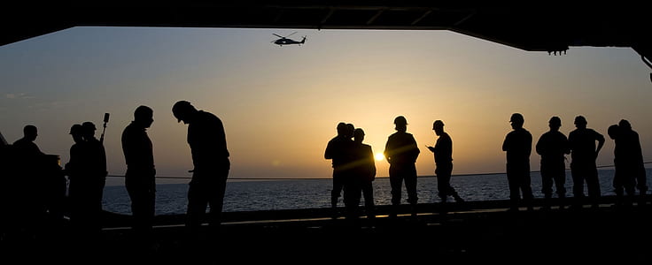people standing on seashore thumbnail