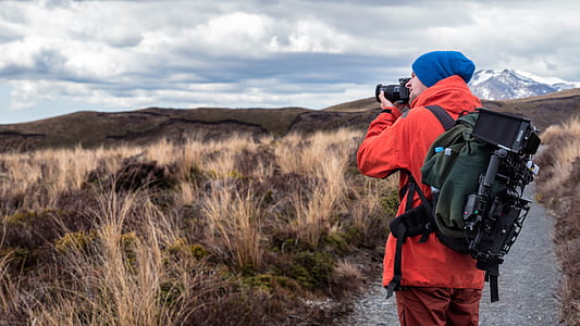 man wearing black jacket taking picture thumbnail