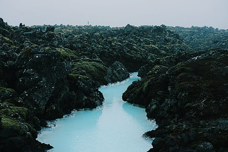 landscape photography of river surrounded with mountain thumbnail