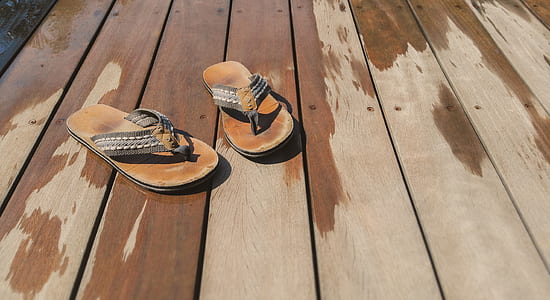 brown flip-flops on brown floor thumbnail