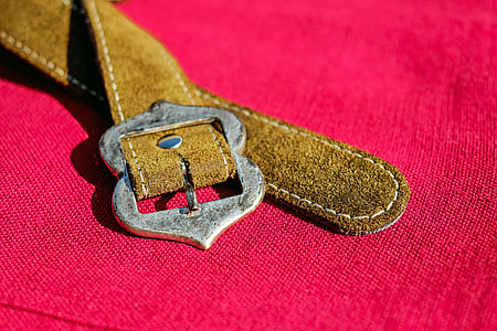 brown leather belt on pink textile thumbnail