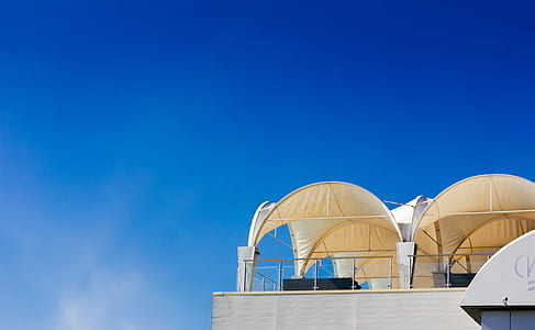 white concrete building under blue sky thumbnail