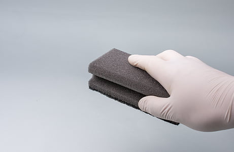 person wearing white glove holding black brick thumbnail