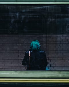 person sitting in front of brown wall thumbnail