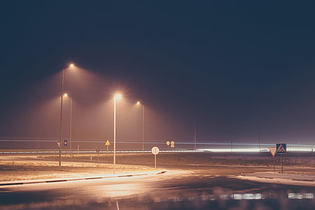 street with powered-on lamppost thumbnail