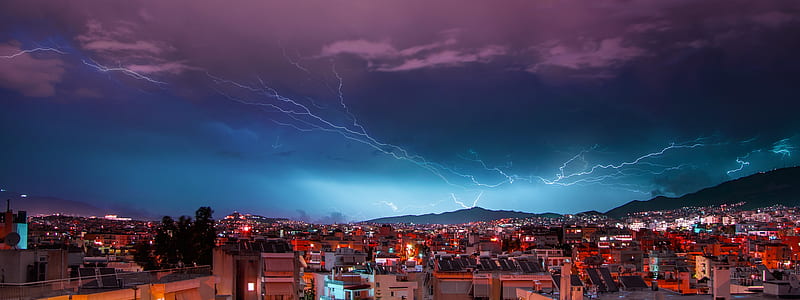aerial photography of buildings over lightning thunder sky thumbnail