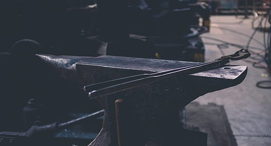 black metal anvil near industrial machine thumbnail