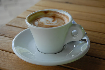 mocha on white ceramic teacup on top of white saucer with thumbnail