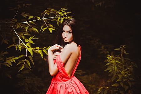 black haired woman in red sleeveless dress thumbnail