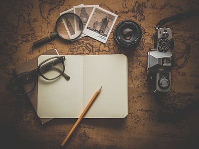 eyeglasses and pencil on white notebook thumbnail