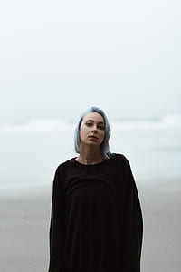 woman in black long-sleeved top posing thumbnail